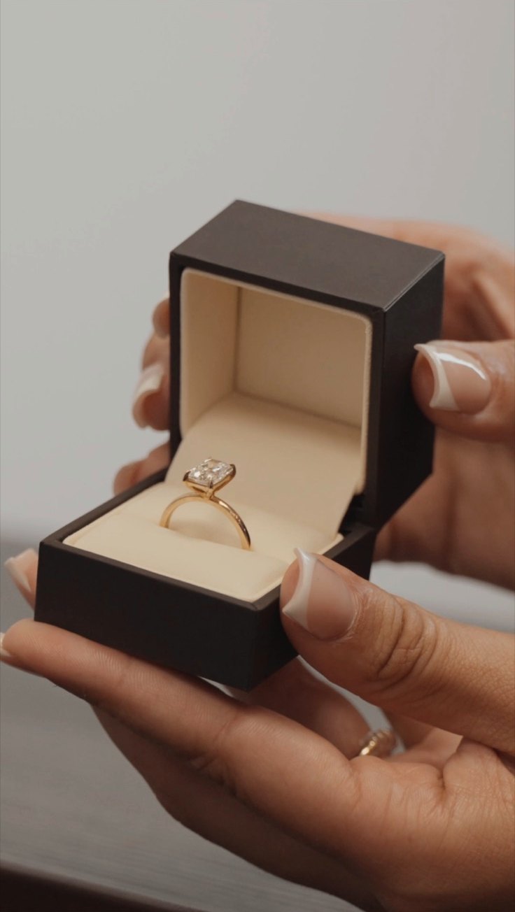 A diamond ring in an open Aura box, browse the collection