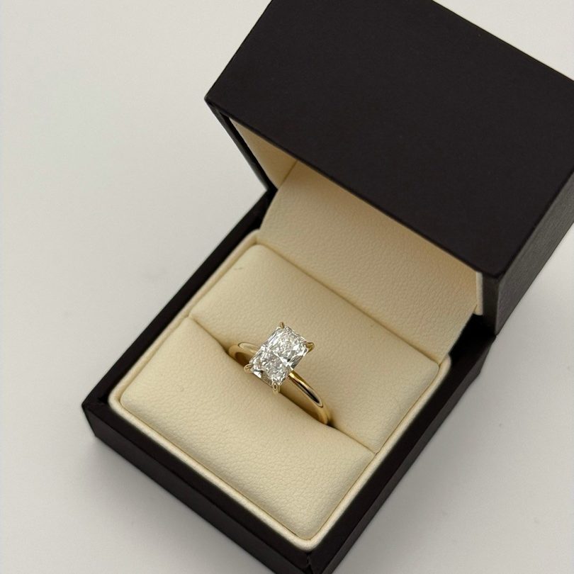 A yellow gold radiant solitaire in its Aura ring box, on Instagram
